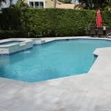 Swimming pool with a pale stone deck