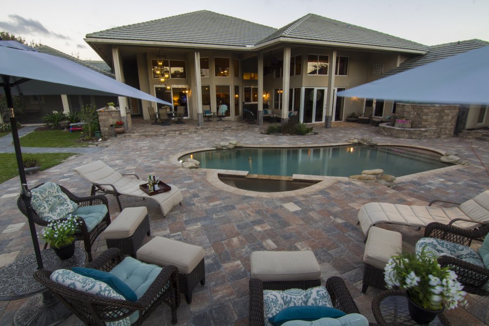 Poolside paver patio with outdoor seating